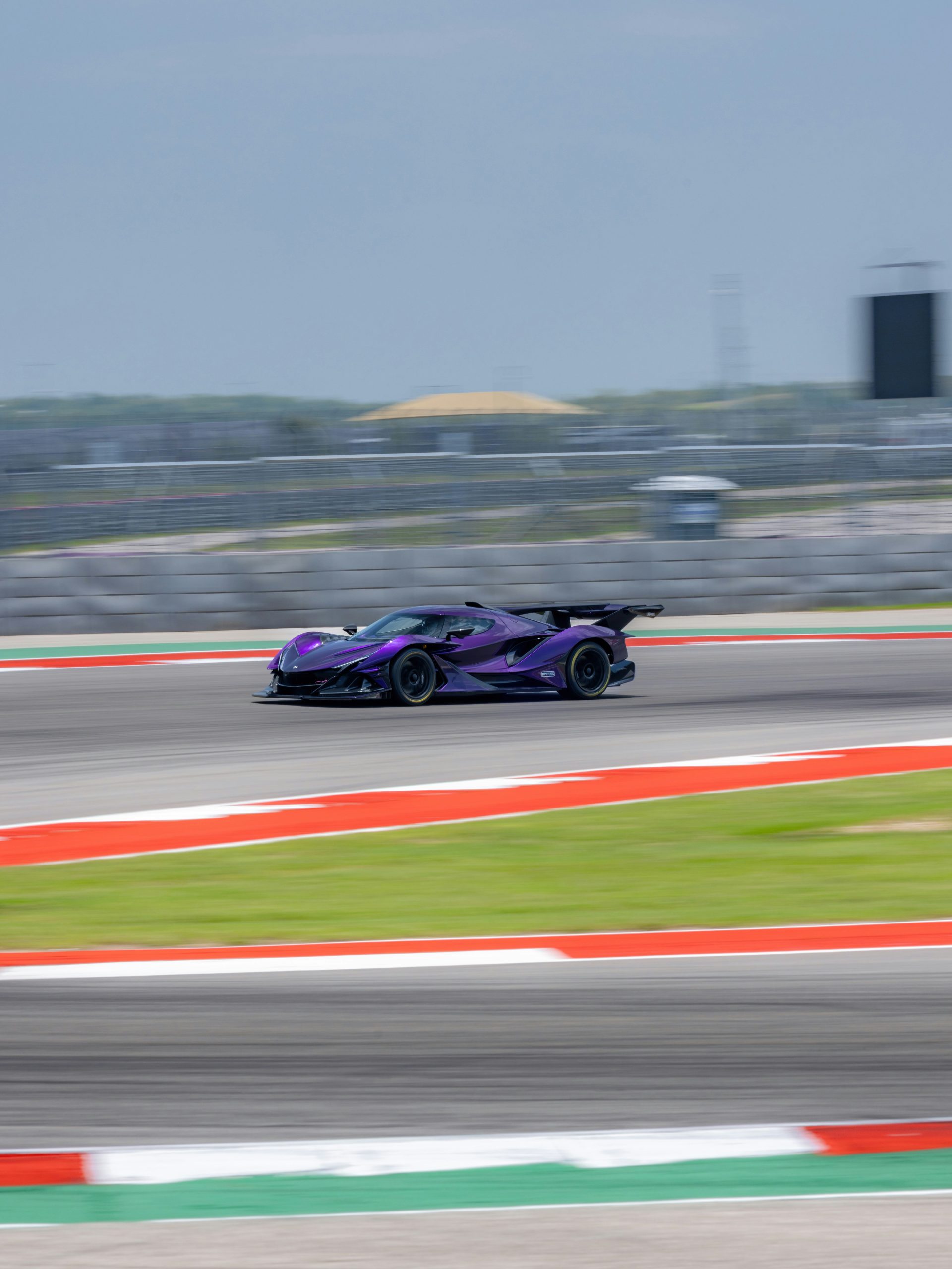 A purple race car driving down a race track